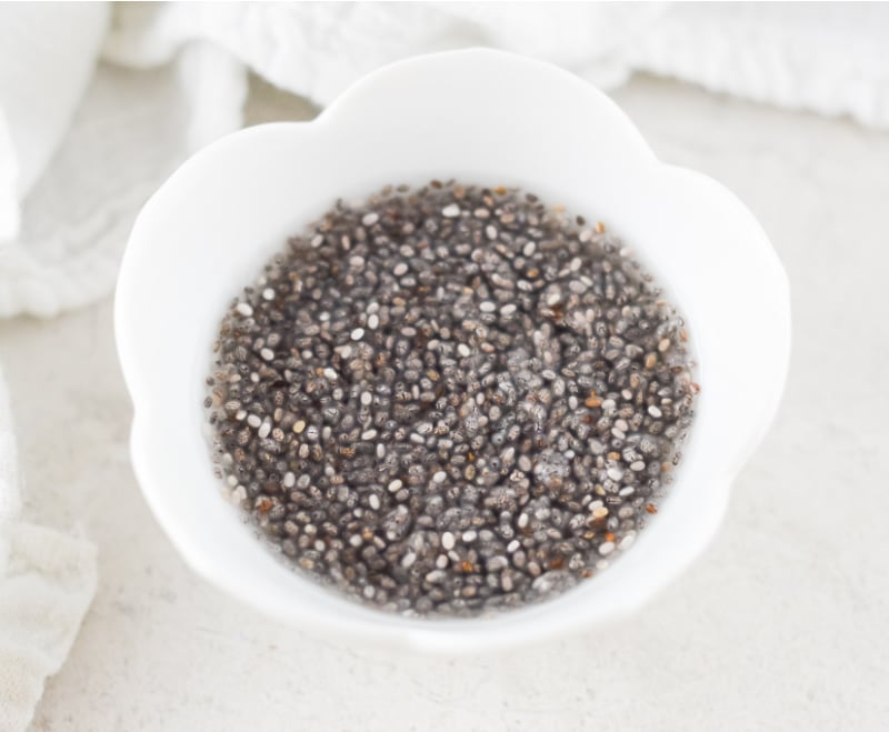 white bowl containing chia seeds and water