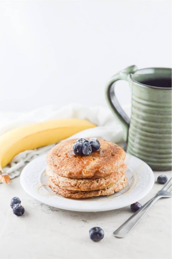 light and airy photo of a stack of whole wheat pancakes in a white plate