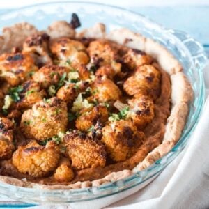 Roasted Cauliflower Tart on a pale blue background