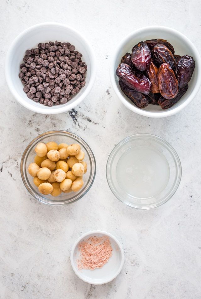 Overhead shot of ingredients needed for making chocolate dipped macadamia nut clusters with date caramel
