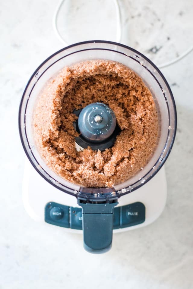 Coconut bites ingredients processed in the bowl of a food processor until combined