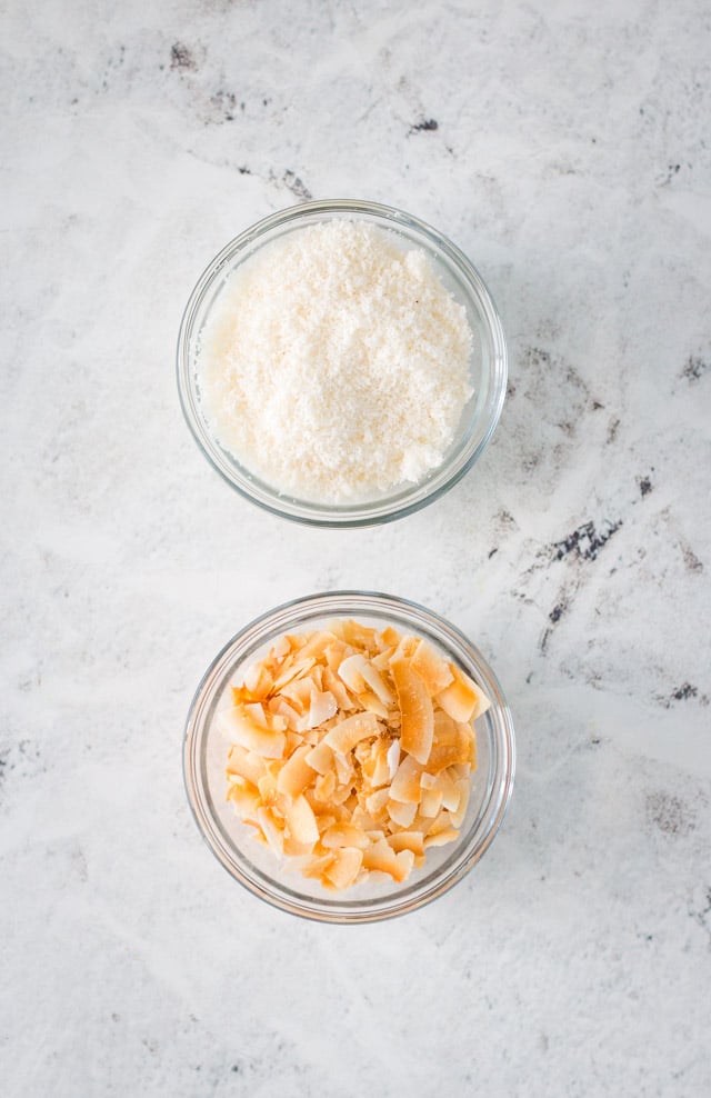 Overhead ingredient shot of desiccated coconut and toasted coconut flakes