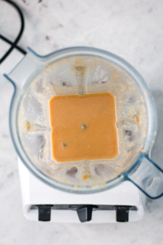 Overhead shot of a creamy butter in the jug of a vitamix blender