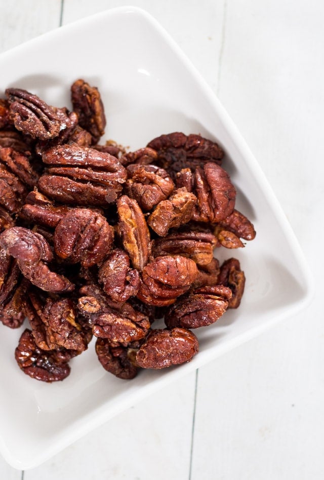 maple glazed pecans in a white serving dish