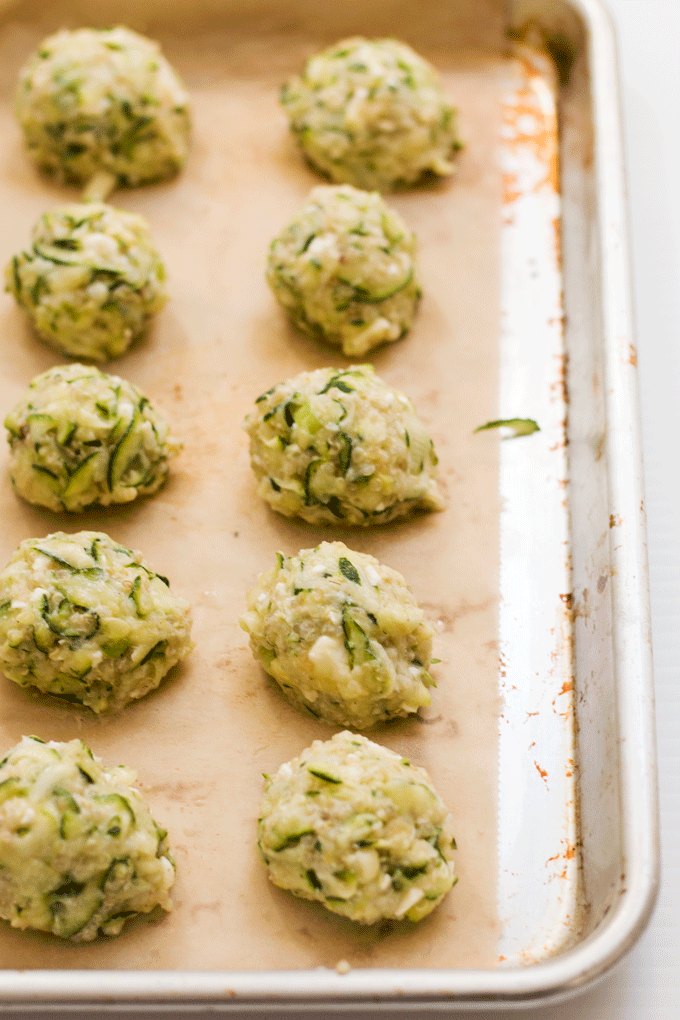 Uncooked Baked Zucchini, Feta and Quinoa Bites on a baking tray