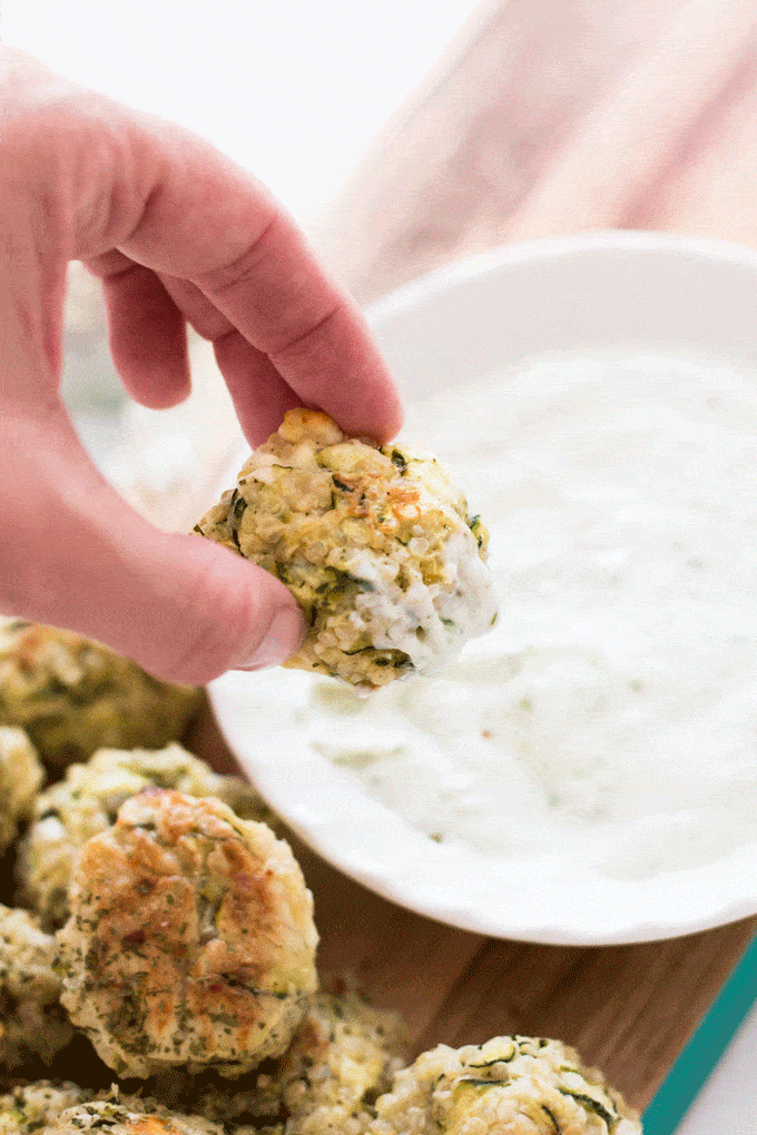 Baked Zucchini, Feta and Quinoa Bites being dipped into aioli