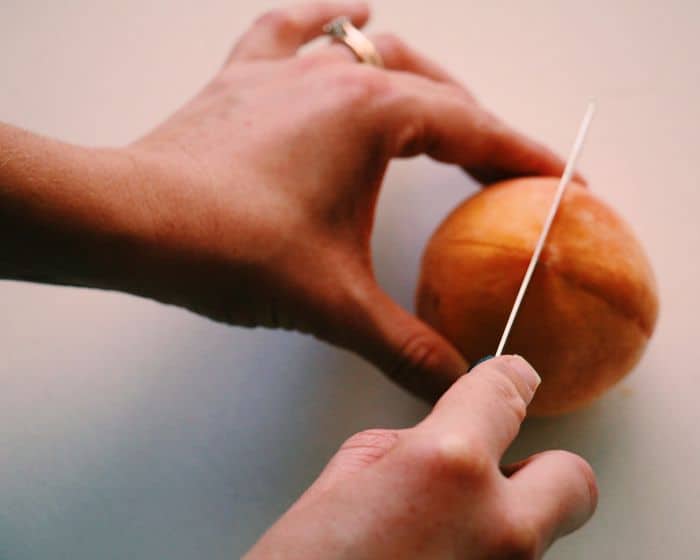 How to perfectly peel a peach: Using a sharp knife, score the bottom of the peach with an X