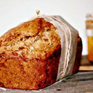 Front view of banana and peach butter bread with a jar of peach butter in the back