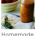 Heirloom Tomato Sauce in a large jar with fresh garlic and thyme scattered