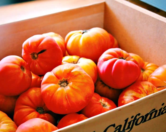 Big California produce box containing lots of fresh heirloom tomatoes