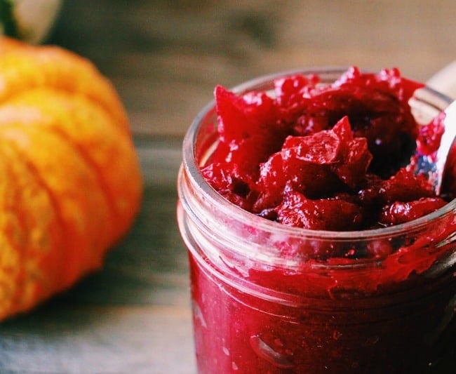 Close up shot of Honey Sweetened Vanilla and Fresh Cranberry Butter with a small pumpkin in the background