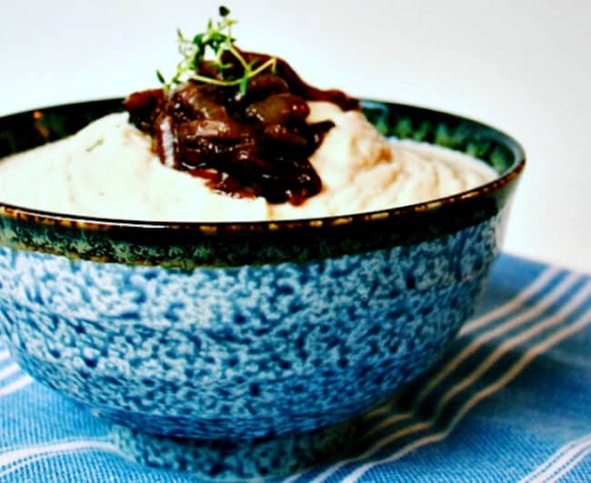 Slow Cooker Garlicky Herbed Cauliflower Mash served in a blue speckled bowl