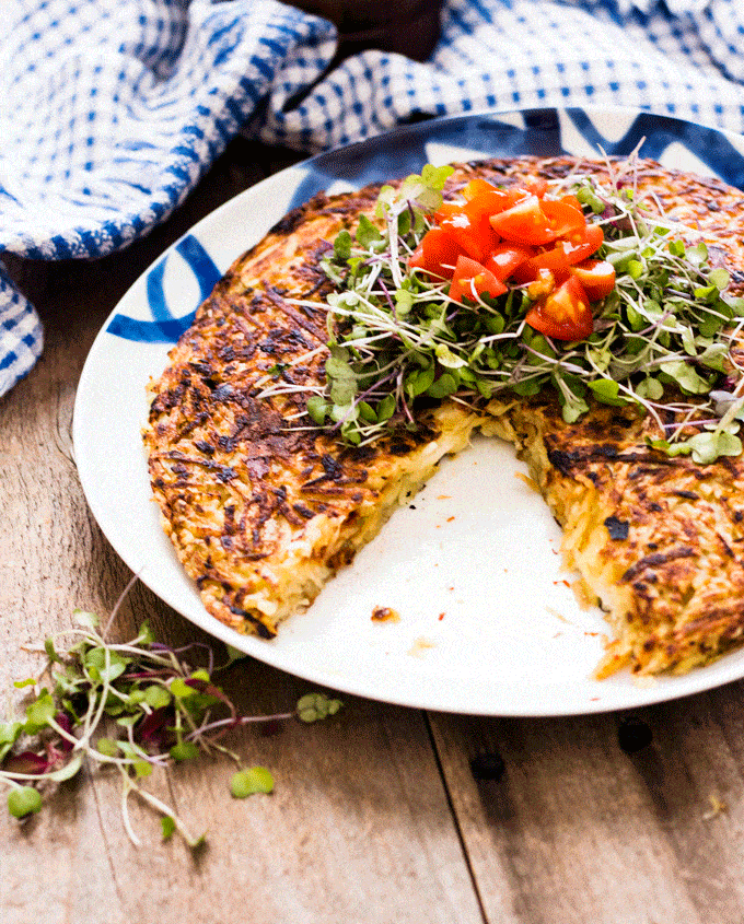 Pizza Stuffed Potato Rosti with cheese served with a small micro greens salad on top