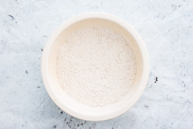 overhead shot of dry ingredients for scones in a white bowl