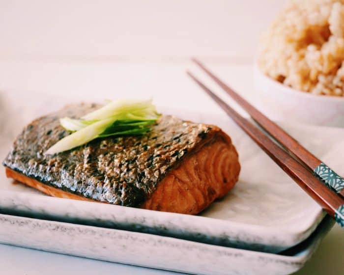 teriyaki salmon with chopsticks