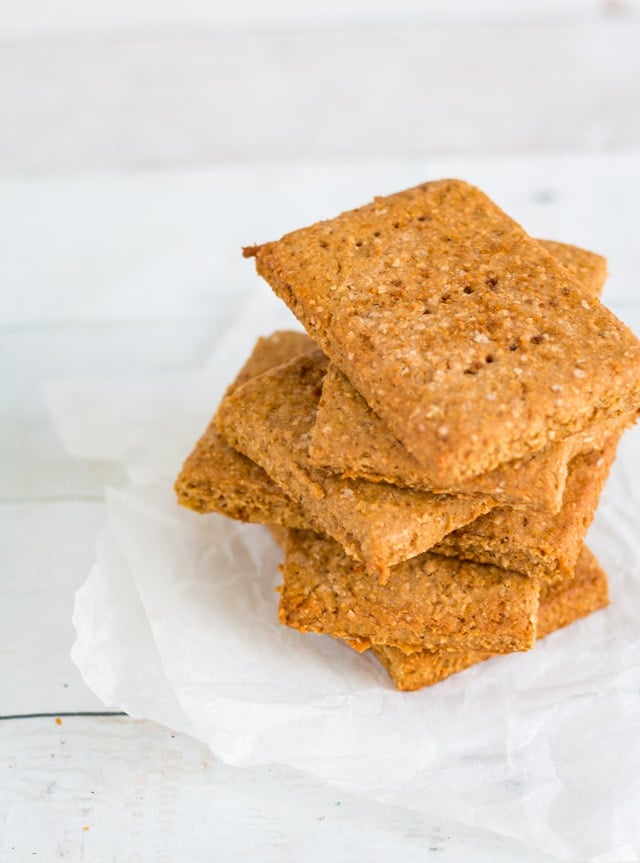 a stack of homemade graham crackers on crumpled parchment paper