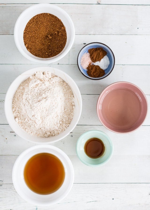 6 colored bowls containing ingredients needed for homemade graham crackers