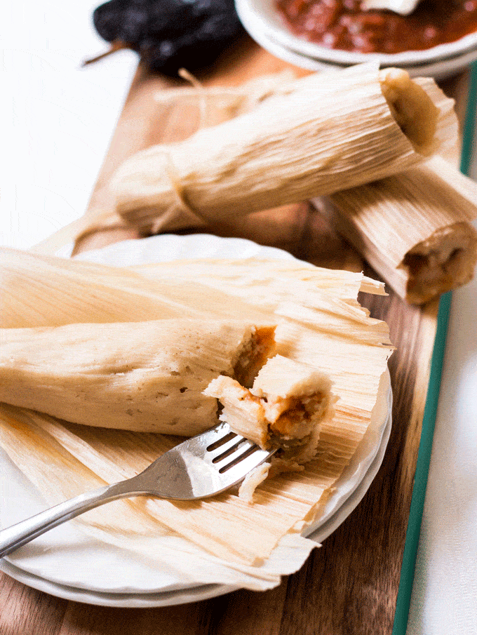 close up shot of potato adobo tamales unwrapped and skewered with a fork