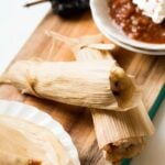 potato adobo tamales on a serving tray with a side of chili