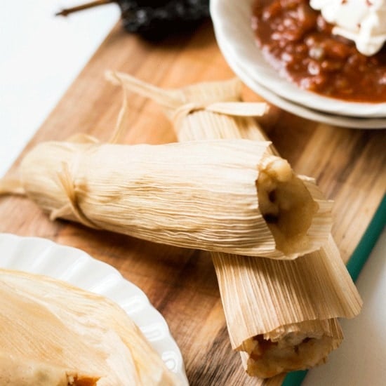 potato adobo tamales on a serving tray with a side of chili