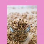 coconut oil granola on a baking tray with a small mason jar full to the brim of granola