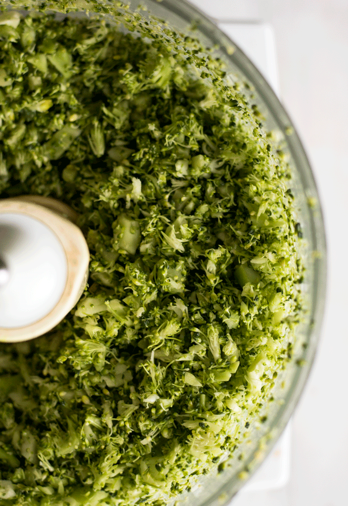 overhead shot of a food processor with chopped broccoli inside