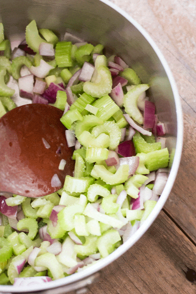 Mixture of chopped celery and onion in saucepan. 6 Ingredient healthy celery soup