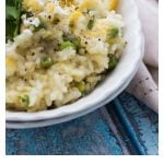 pea and asparagus pressure cooker risotto in white bowls with bluebells in the background