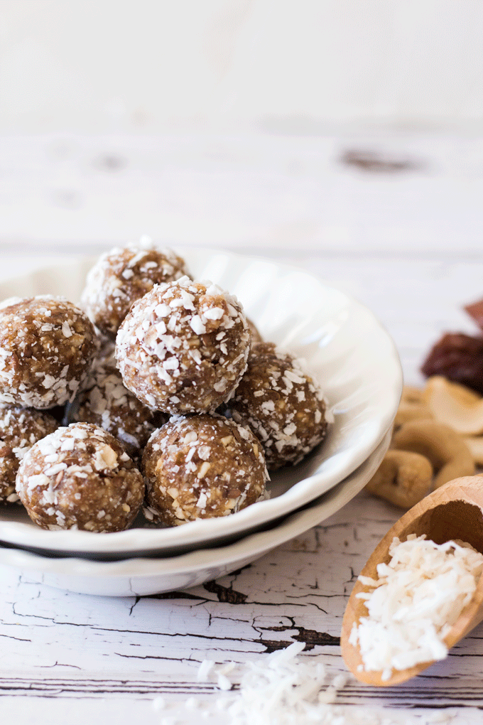 A pile of Easy No Bake Cashew and Coconut Date Balls in a white bowl