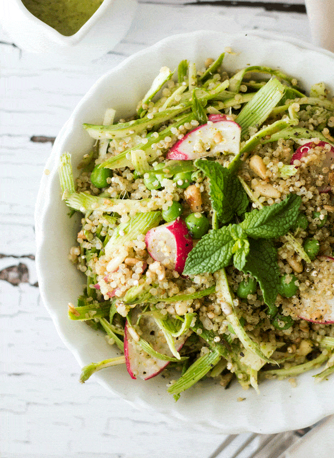 Close up shot of Radish Pea and Quinoa Shaved Asparagus Salad in a white bowl