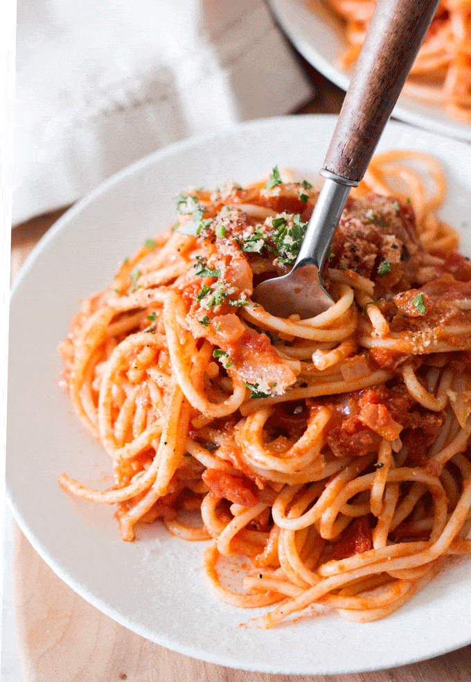 Vegan Tomato Cream Sauce with Spaghetti plated and being swirled with a fork