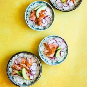 teriyaki salmon rice bowl on a yellow background