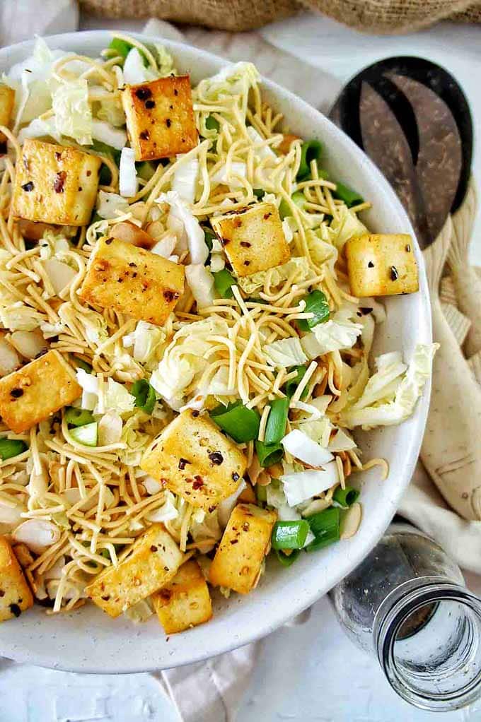 Up close shot of Crispy Tofu Fried Noodle Salad in a white bowl