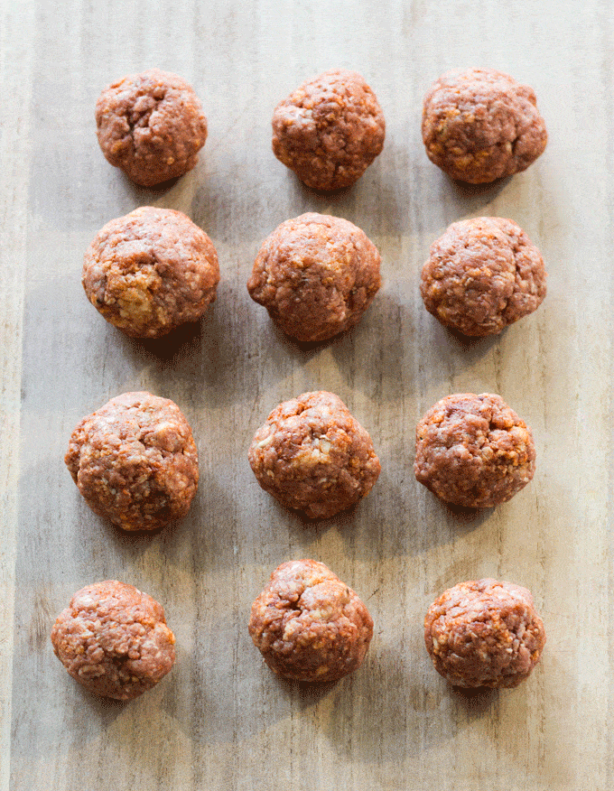 Raw meatballs being rolled for A Smokey Spanish Meatballs Recipe 