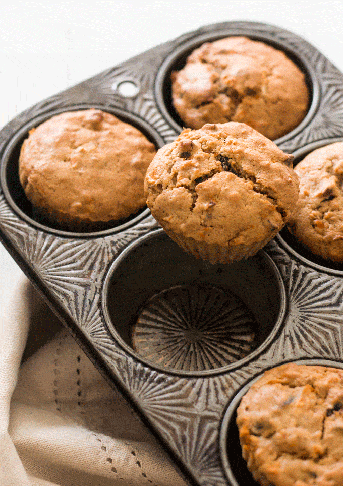 Single Protein Rich Carrot Cake Muffins on top of muffin tray with other muffins in the background