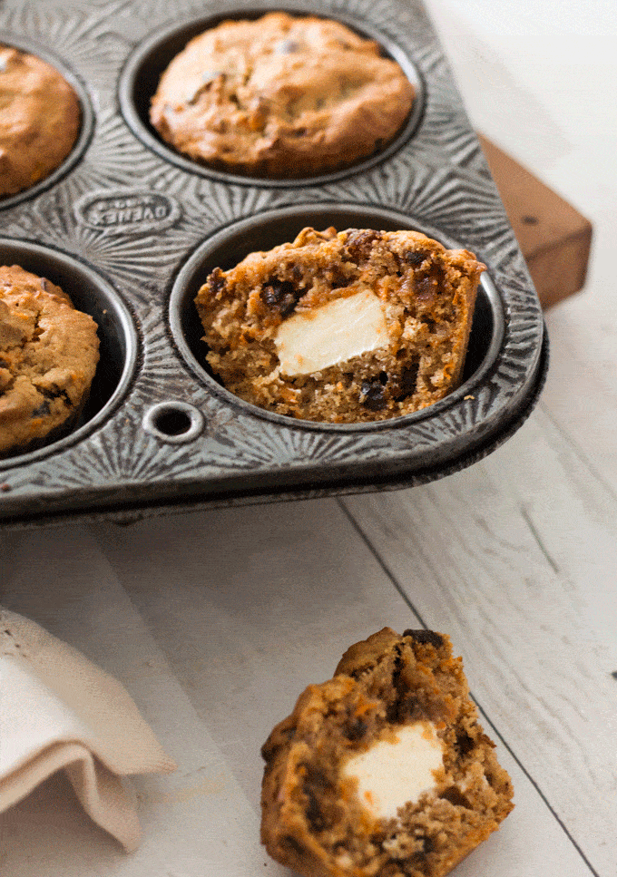 Protein Rich Carrot Cake Muffins cut in half to show the cream cheese inside