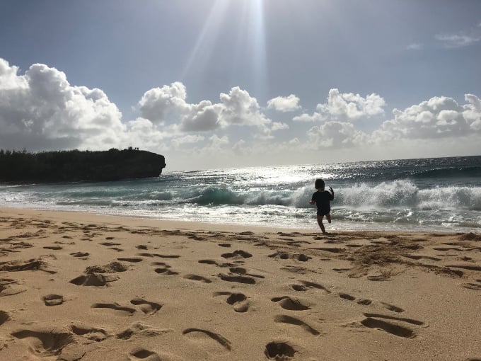 Foodie travel with kids: kid playing on the beach