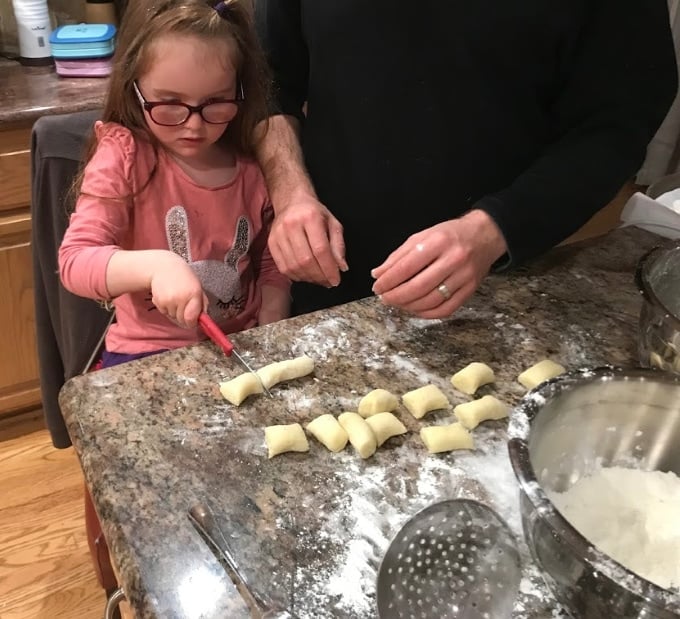 Foodie Travel with kids: child making gnocchi