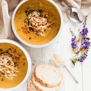 Instant pot soup recipes: Cheesy Broccoli Cauliflower Soup served in white bowls with bread and butter