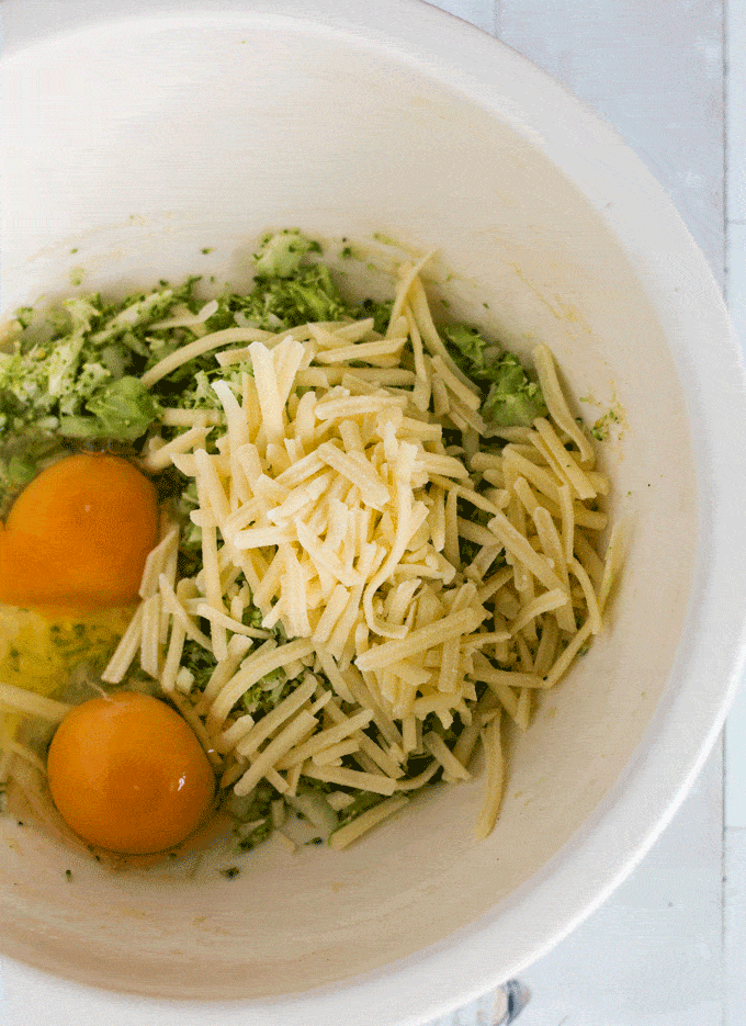 Ingredients for Cheddar Broccoli Fritters in a white bowl
