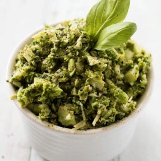 Pesto Broccoli Rice in a white bowl on wooden background