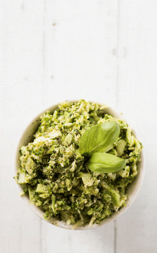 pesto broccoli rice served in a small white bowl against a wooden background