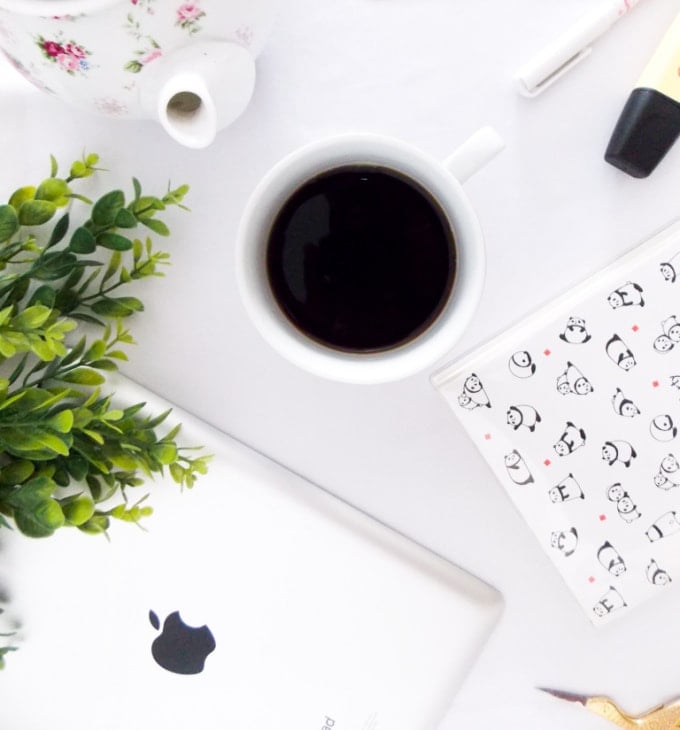 computer and coffee cup flat lay