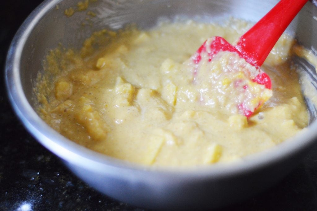 Mixing keto mini muffin ingredients together in a metal bowl.