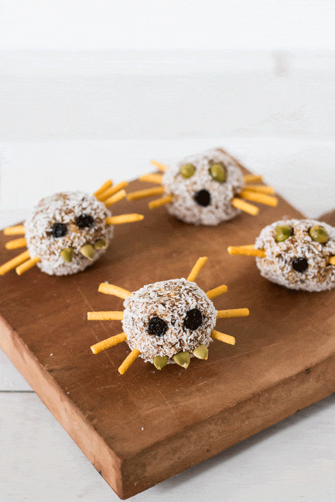 Halloween Breakfast Balls: mini breakfast ball decorated with pretzel sticks as legs and dried berries as eyes