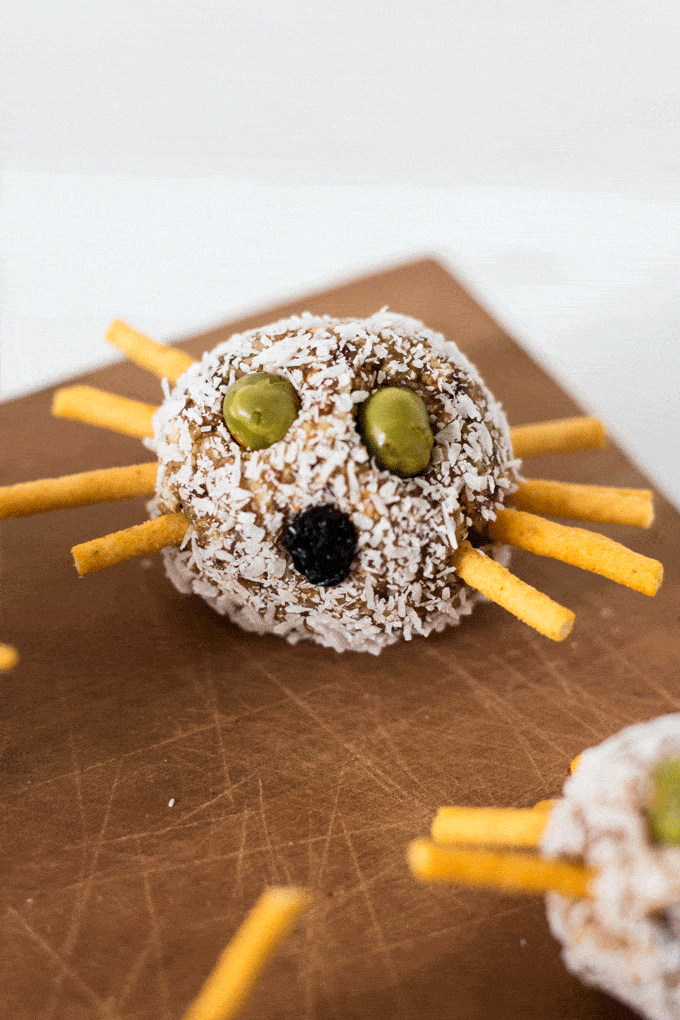 Mini Halloween Breakfast Balls decorated with dried peas as eyes and crispy noodles as legs