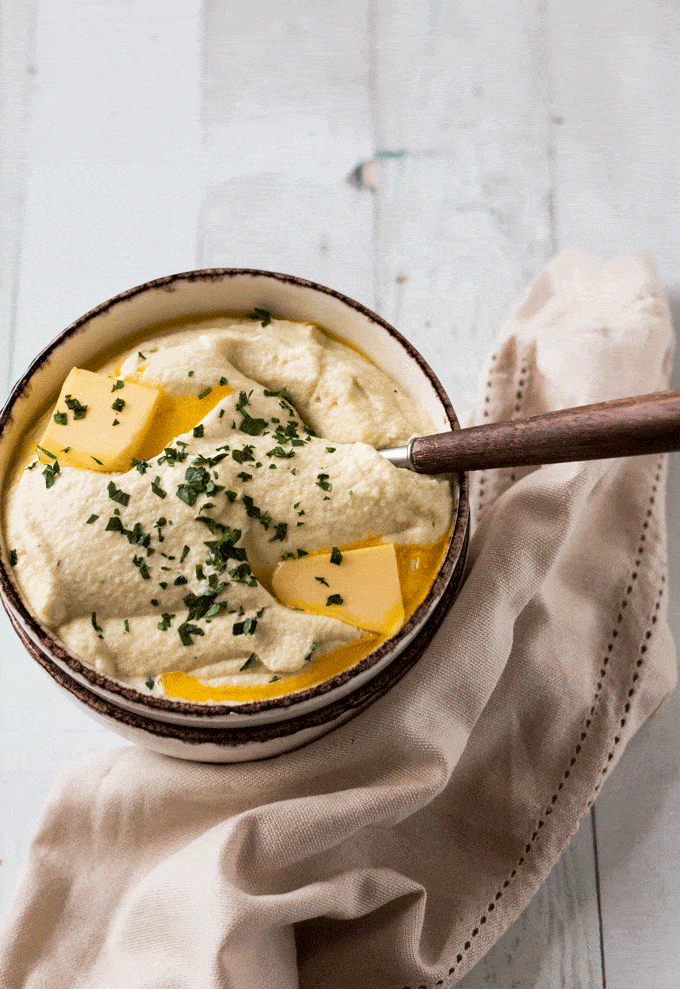 Bowl of Roasted Parsnip Puree with a wooden spoon protruding out