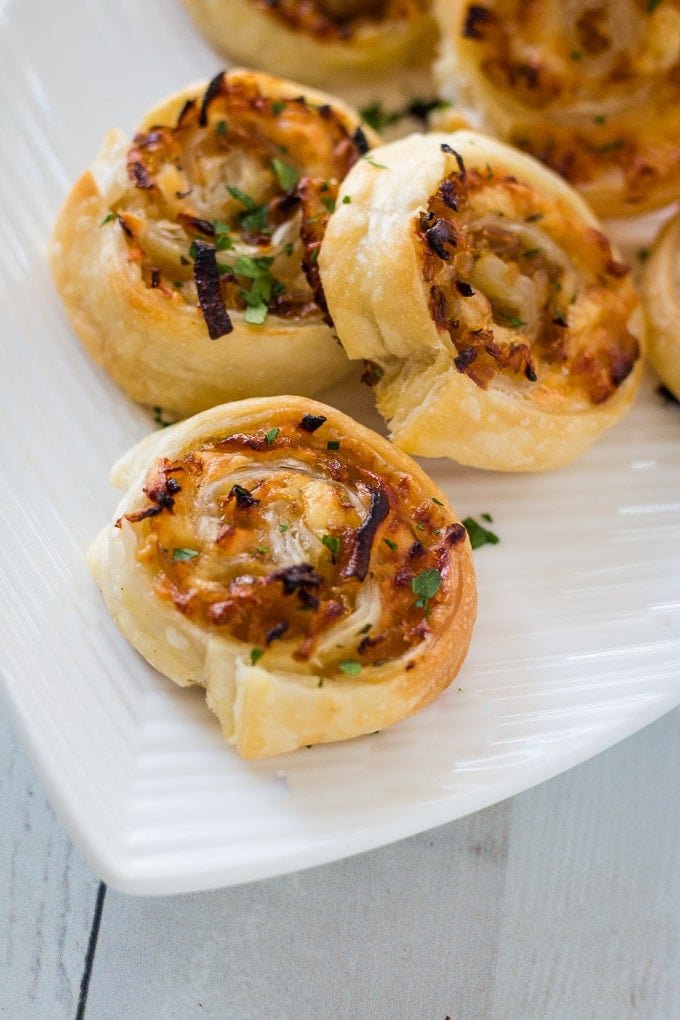 caramelized onion puff pastry appetizers on a white plate