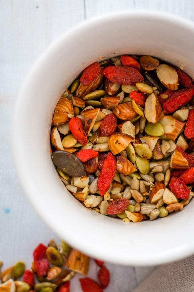 A mixture of toasted almonds, pepitas, pumpkin seeds and goji berries for topping winter porridge with almond milk