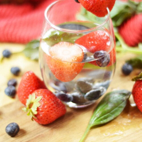 Basil and berries infused in a glass of water